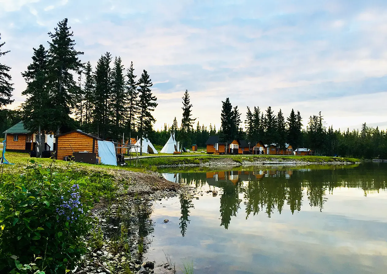 Community of cabins and tents along a lakeside
